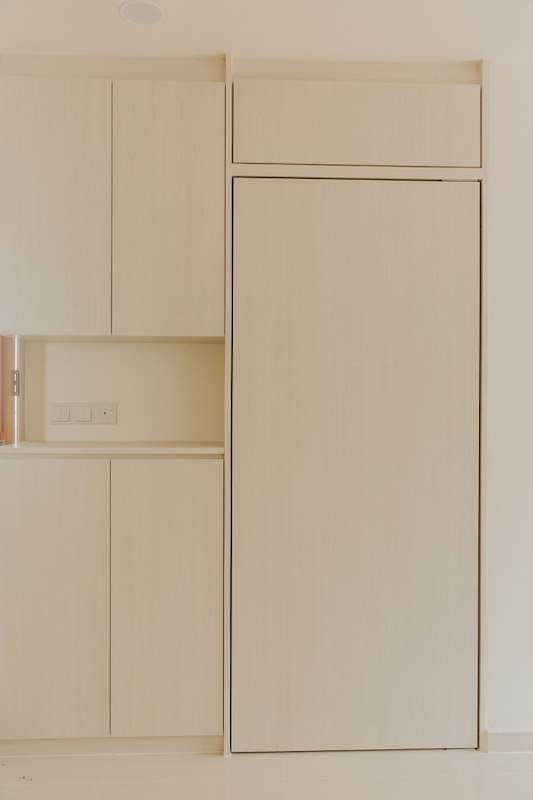 White laminate cabinet by the entrance with a full-height door and a small open niche - HDB flat renovation with a glass-partitioned study, hidden shoe cabinet and navy kitchen (442BB) | Larry Contractors, HDB Licensed Renovation Contractor, Singapore