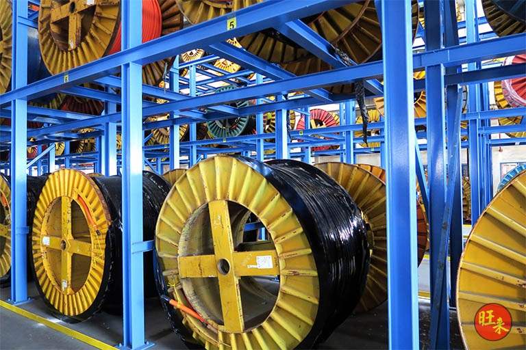 Close view of drums on the ground tier of the rack with the upper tier loaded above - Heavy-duty cable drum racking in a cable yard (TSE) | Larry Contractors, HDB Licensed Renovation Contractor, Singapore