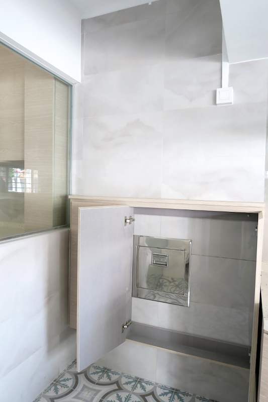 After: yard corner with marble-look wall tiles, a half-height glass partition and a small wall cabinet - HDB kitchen, bathroom and service yard renovation (140PP) | Larry Contractors, HDB Licensed Renovation Contractor, Singapore