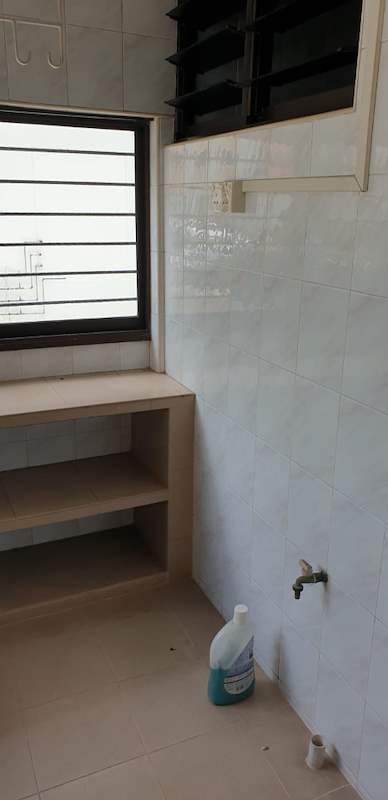 Before: the old service yard with white tiles, a low shelf unit and a window - HDB resale flat renovation with polished terrazzo floors, new kitchen and bathrooms (C04) | Larry Contractors, HDB Licensed Renovation Contractor, Singapore
