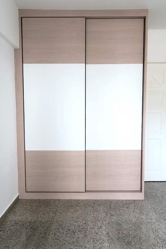 Sliding-door wardrobe in light wood and white laminate with the doors closed - HDB resale flat renovation with polished terrazzo floors, new kitchen and bathrooms (C04) | Larry Contractors, HDB Licensed Renovation Contractor, Singapore