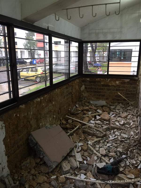 During works: the laundry corner with stripped walls, rubble and corner windows - HDB resale flat renovation with polished terrazzo floors, new kitchen and bathrooms (C04) | Larry Contractors, HDB Licensed Renovation Contractor, Singapore