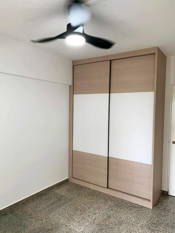 Bedroom after renovation with a light wood and white sliding-door wardrobe, ceiling fan and terrazzo floor - HDB resale flat renovation with polished terrazzo floors, new kitchen and bathrooms (C04) | Larry Contractors, HDB Licensed Renovation Contractor, Singapore