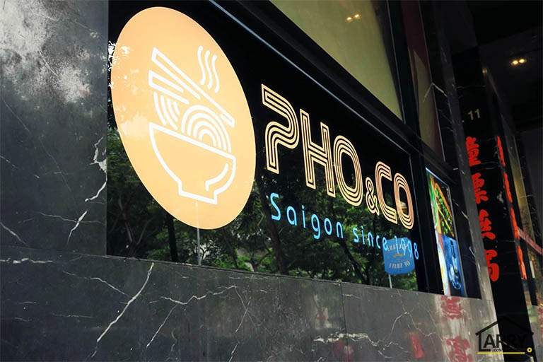 Close view of the backlit restaurant sign set into the dark marble shopfront - Restaurant fit-out with an open kitchen counter and marble frontage (C48) | Larry Contractors, HDB Licensed Renovation Contractor, Singapore