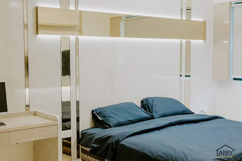 Bedroom with mirror-strip wall panels, a backlit floating shelf and a blue-covered bed - HDB flat renovation in cream and mirror-trim laminate with a galley kitchen (C10) | Larry Contractors, HDB Licensed Renovation Contractor, Singapore