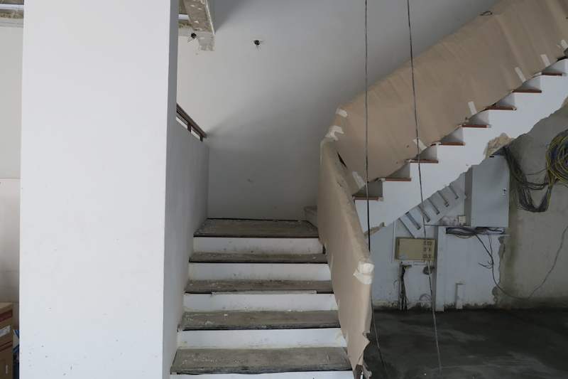 During works: the bare internal staircase before finishes, with wiring still exposed and walls unpainted - Landed house renovation with new facade, staircase and interiors (39EW) | Larry Contractors, HDB Licensed Renovation Contractor, Singapore