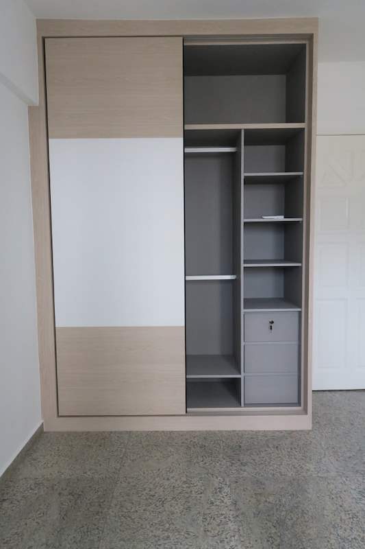 Sliding-door wardrobe half open showing grey shelving, a hanging rail and drawers - HDB resale flat renovation with polished terrazzo floors, new kitchen and bathrooms (C04) | Larry Contractors, HDB Licensed Renovation Contractor, Singapore