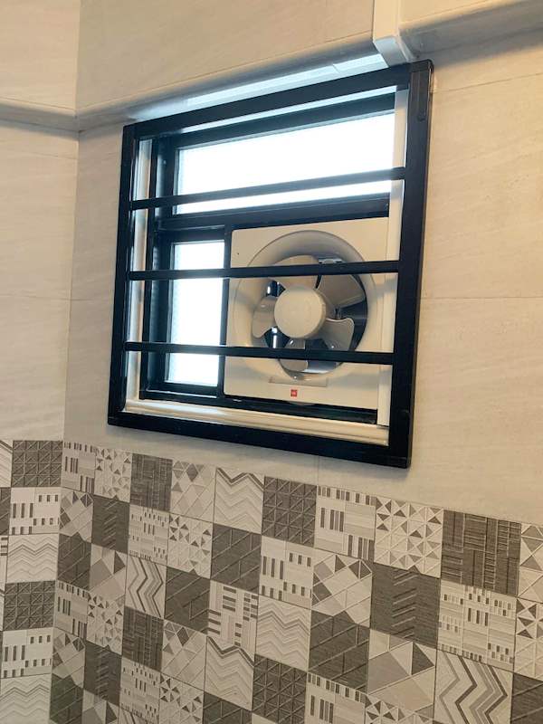 Black-framed window with an exhaust fan above a patterned tile band - HDB resale flat renovation with polished terrazzo floors, new kitchen and bathrooms (C04) | Larry Contractors, HDB Licensed Renovation Contractor, Singapore