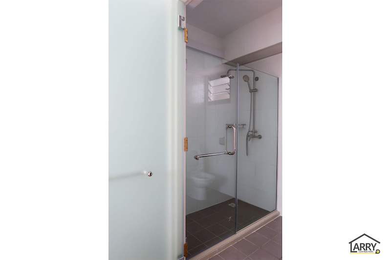 Bathroom doorway showing the glass shower screen and shower fittings - HDB flat renovation with a platform bay window seat and blue kitchen (C20) | Larry Contractors, HDB Licensed Renovation Contractor, Singapore