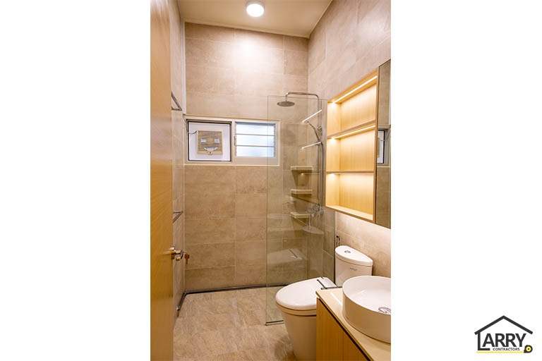 Bathroom with marble-look wall tiles, a glass shower screen, lit shelving and a countertop basin - HDB flat renovation with full-height carpentry and a wood-tone kitchen (C12) | Larry Contractors, HDB Licensed Renovation Contractor, Singapore