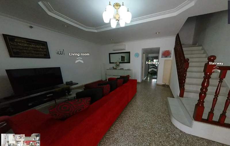 Before: the original living room with a terrazzo floor, a red sofa and a timber-balustrade staircase - Terrace house renovation with new facade and full interior (3TBA) | Larry Contractors, HDB Licensed Renovation Contractor, Singapore