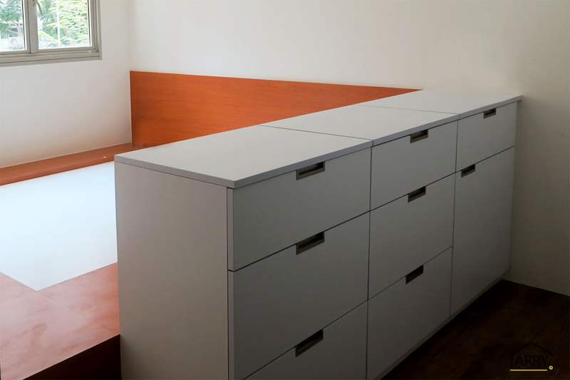 Row of white built-in drawers along the edge of the raised bedroom platform - HDB flat renovation with a platform bay window seat and blue kitchen (C20) | Larry Contractors, HDB Licensed Renovation Contractor, Singapore