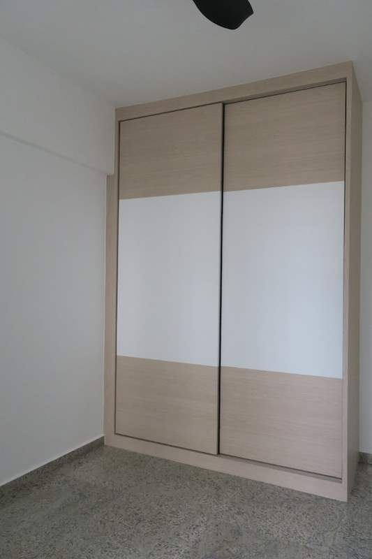 Sliding-door wardrobe in light wood and white laminate with the doors closed - HDB resale flat renovation with polished terrazzo floors, new kitchen and bathrooms (C04) | Larry Contractors, HDB Licensed Renovation Contractor, Singapore