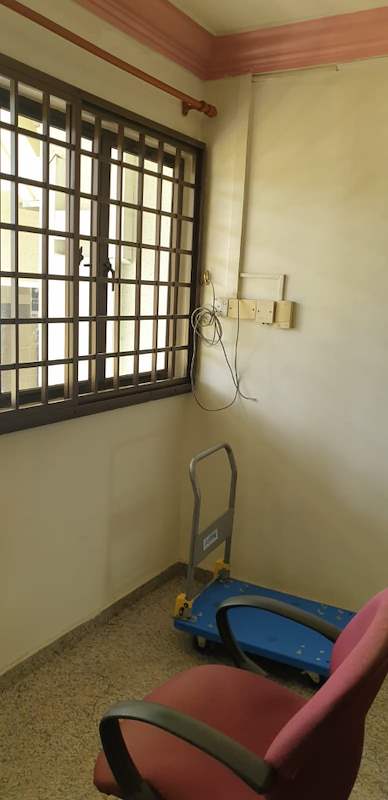 Before: an old room with a pink cornice, window grilles, an office chair and a trolley - HDB resale flat renovation with polished terrazzo floors, new kitchen and bathrooms (C04) | Larry Contractors, HDB Licensed Renovation Contractor, Singapore