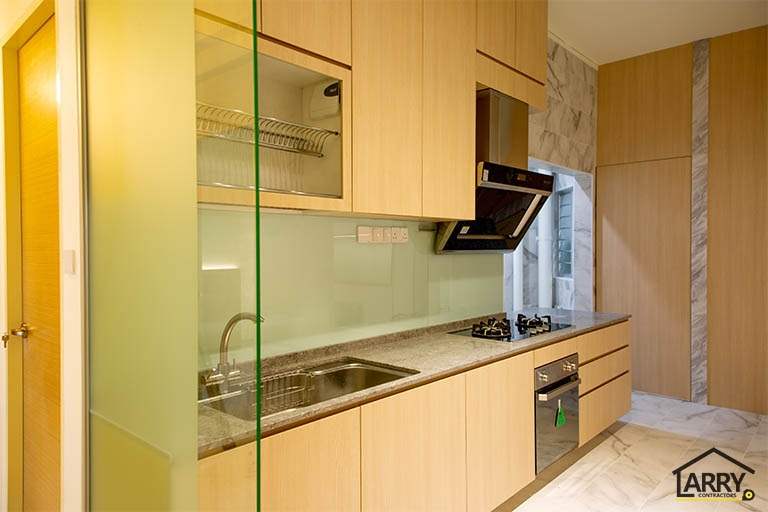 Kitchen with light wood-tone cabinets, a glass splashback, built-in oven and cooker hood - HDB flat renovation with full-height carpentry and a wood-tone kitchen (C12) | Larry Contractors, HDB Licensed Renovation Contractor, Singapore