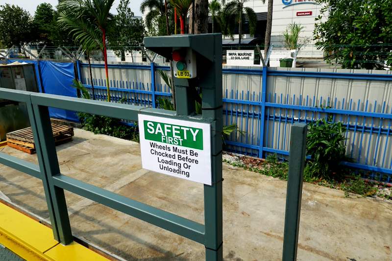 Safety railing on the dock platform with a safety-first notice board - Heavy-duty cable drum racking in a cable yard (TSE) | Larry Contractors, HDB Licensed Renovation Contractor, Singapore