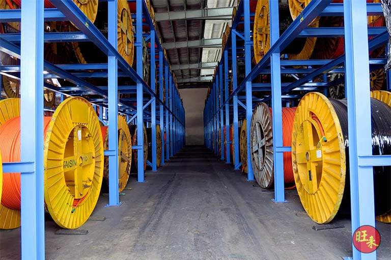 Cable drums on both tiers of the rack, looking down the aisle to the far end of the shed - Heavy-duty cable drum racking in a cable yard (TSE) | Larry Contractors, HDB Licensed Renovation Contractor, Singapore