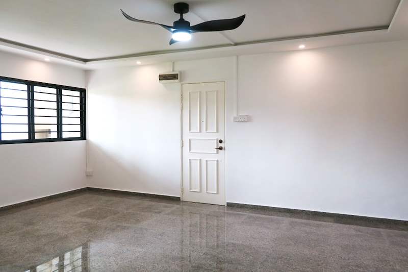 Living room with a grilled window, white door and polished terrazzo floor - HDB resale flat renovation with polished terrazzo floors, new kitchen and bathrooms (C04) | Larry Contractors, HDB Licensed Renovation Contractor, Singapore