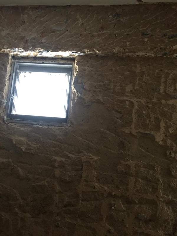 During works: a hacked wall with exposed brick around a small window opening - HDB resale flat renovation with polished terrazzo floors, new kitchen and bathrooms (C04) | Larry Contractors, HDB Licensed Renovation Contractor, Singapore
