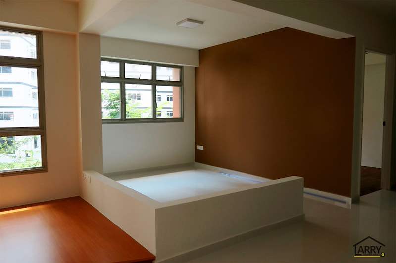 The living room platform meeting the brown feature wall, with the hallway to the bedrooms beyond - HDB flat renovation with a platform bay window seat and blue kitchen (C20) | Larry Contractors, HDB Licensed Renovation Contractor, Singapore