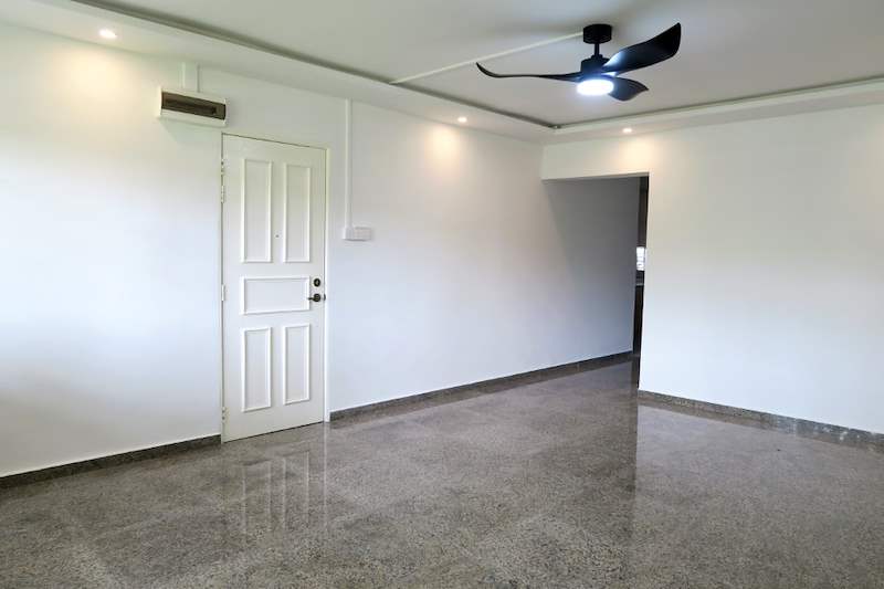 Living room with a white panelled door, ceiling fan light and hallway beyond - HDB resale flat renovation with polished terrazzo floors, new kitchen and bathrooms (C04) | Larry Contractors, HDB Licensed Renovation Contractor, Singapore