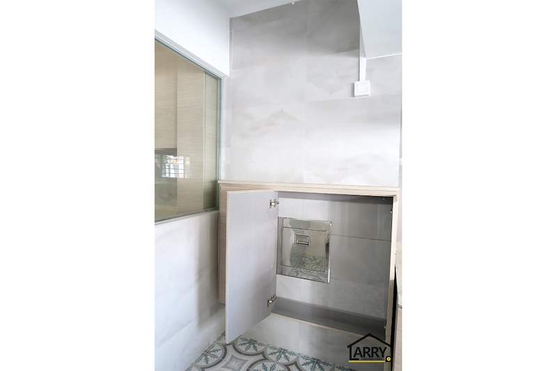 Kitchen corner cabinet with a door open, marble-look wall tiles and patterned floor - HDB resale flat renovation with polished terrazzo floors, new kitchen and bathrooms (C04) | Larry Contractors, HDB Licensed Renovation Contractor, Singapore