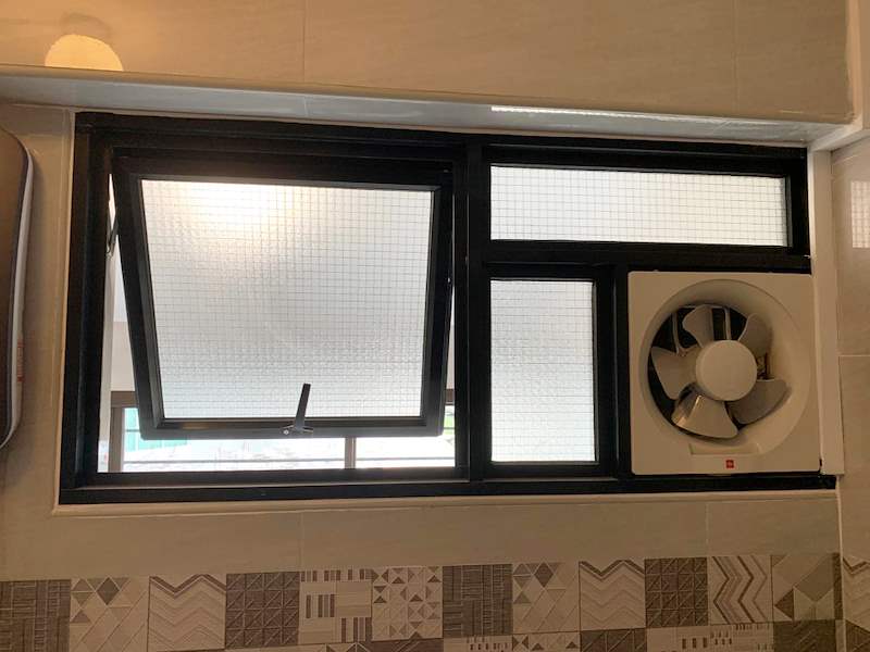Black-framed window with an exhaust fan above a patterned tile band - HDB resale flat renovation with polished terrazzo floors, new kitchen and bathrooms (C04) | Larry Contractors, HDB Licensed Renovation Contractor, Singapore