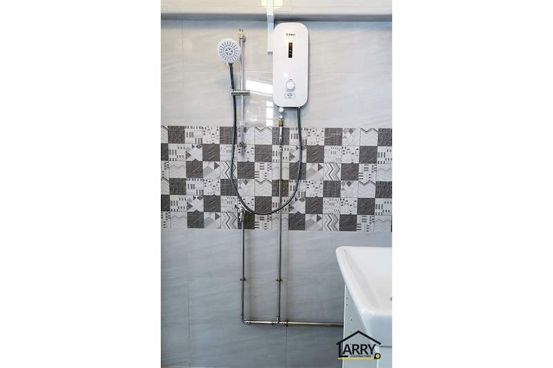Shower with an instant water heater and hand shower above a patterned tile band - HDB resale flat renovation with polished terrazzo floors, new kitchen and bathrooms (C04) | Larry Contractors, HDB Licensed Renovation Contractor, Singapore