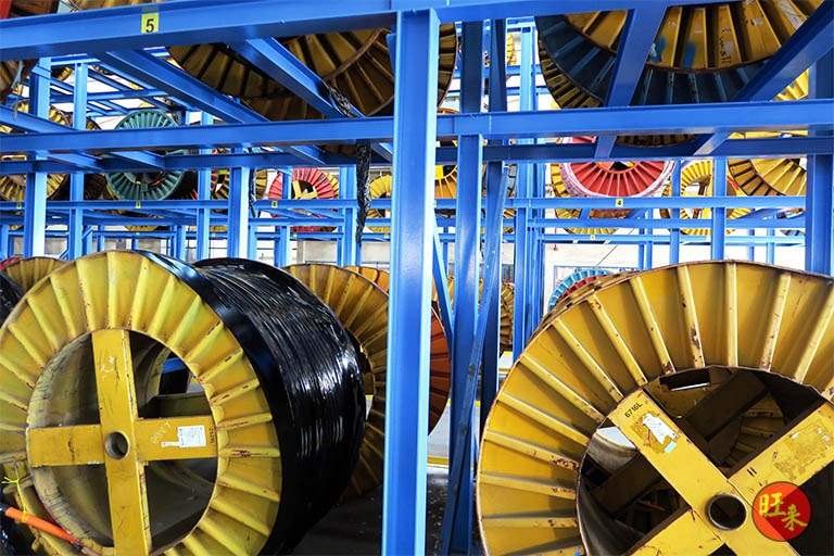 Two large drums on the lower tier of the rack under the loaded upper beams - Heavy-duty cable drum racking in a cable yard (TSE) | Larry Contractors, HDB Licensed Renovation Contractor, Singapore