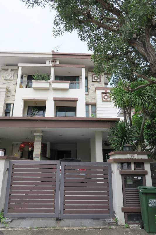 Before: the original two-storey house with a cream rendered facade, tiled roof and timber-slat gate - Landed house renovation with new facade, staircase and interiors (39EW) | Larry Contractors, HDB Licensed Renovation Contractor, Singapore