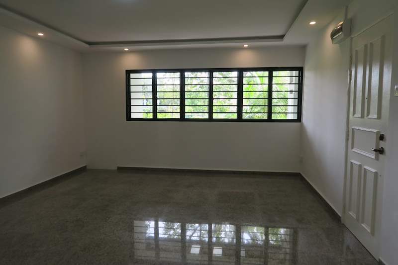 Living room with a grilled window, white door and polished terrazzo floor - HDB resale flat renovation with polished terrazzo floors, new kitchen and bathrooms (C04) | Larry Contractors, HDB Licensed Renovation Contractor, Singapore