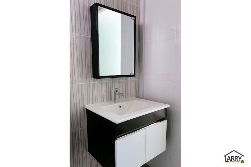 Wall-hung bathroom vanity with white drawers, a black mirror frame and striped feature tiles - HDB flat renovation with a platform bay window seat and blue kitchen (C20) | Larry Contractors, HDB Licensed Renovation Contractor, Singapore