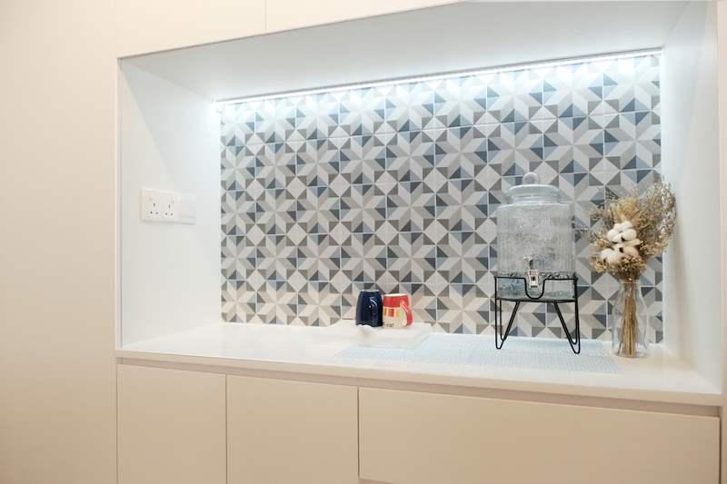 Backlit display niche with patterned blue and white tiles above white cabinets - HDB flat renovation with a navy kitchen and a glass-walled walk-in wardrobe (407B) | Larry Contractors, HDB Licensed Renovation Contractor, Singapore