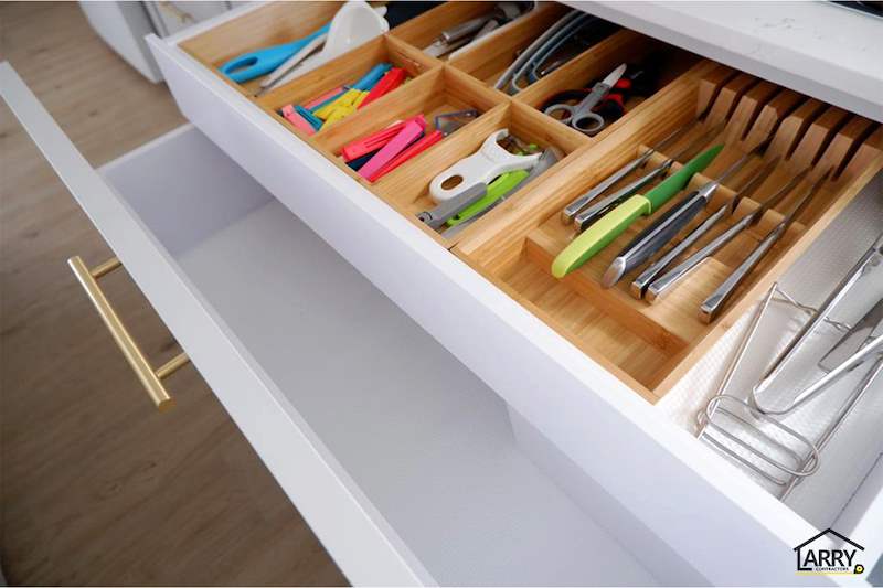 Kitchen drawer with a bamboo cutlery and utensil organiser, white shaker front and brass handle - HDB flat renovation in white shaker-style carpentry with brass handles (C05) | Larry Contractors, HDB Licensed Renovation Contractor, Singapore