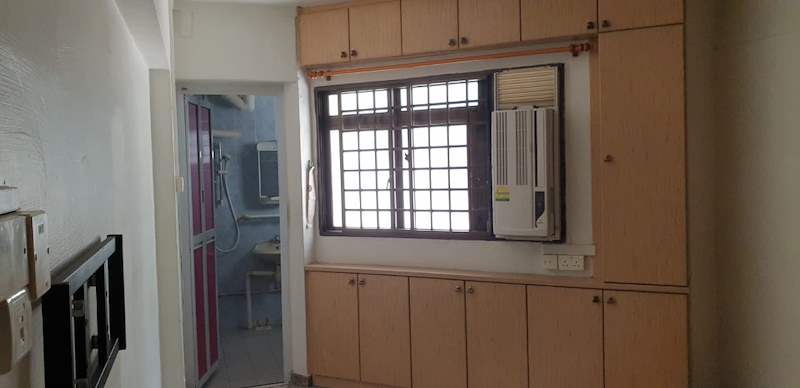Before: the old kitchen cabinets and a window air-conditioning unit - HDB resale flat renovation with polished terrazzo floors, new kitchen and bathrooms (C04) | Larry Contractors, HDB Licensed Renovation Contractor, Singapore