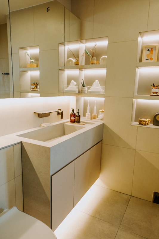 Vanity with a stone basin, lit display niches in the wall and a mirror above - Full HDB maisonette renovation with a curved timber-slat island and lit staircase (140BB) | Larry Contractors, HDB Licensed Renovation Contractor, Singapore
