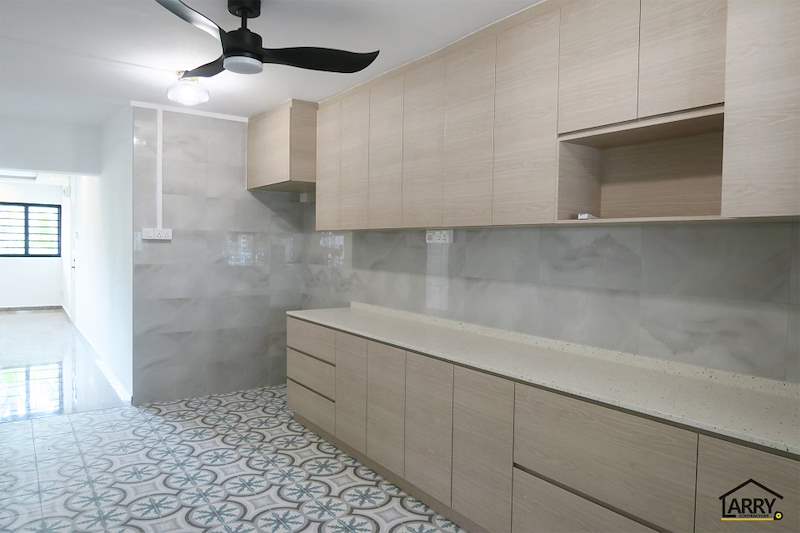 Kitchen with a ceiling fan, light wood upper and lower cabinets and a window at the end - HDB resale flat renovation with polished terrazzo floors, new kitchen and bathrooms (C04) | Larry Contractors, HDB Licensed Renovation Contractor, Singapore