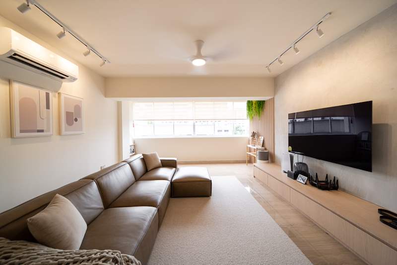 After: living room with a long brown sofa, floating TV console and a timber-slat wall with plants - Full HDB maisonette renovation with a curved timber-slat island and lit staircase (140BB) | Larry Contractors, HDB Licensed Renovation Contractor, Singapore