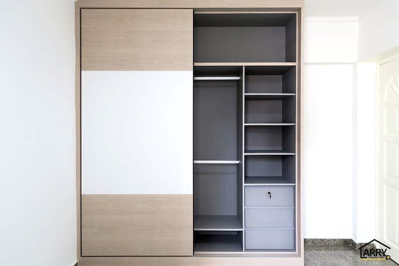 Sliding-door wardrobe half open showing grey shelves, a hanging rail and drawers - HDB resale flat renovation with polished terrazzo floors, new kitchen and bathrooms (C04) | Larry Contractors, HDB Licensed Renovation Contractor, Singapore