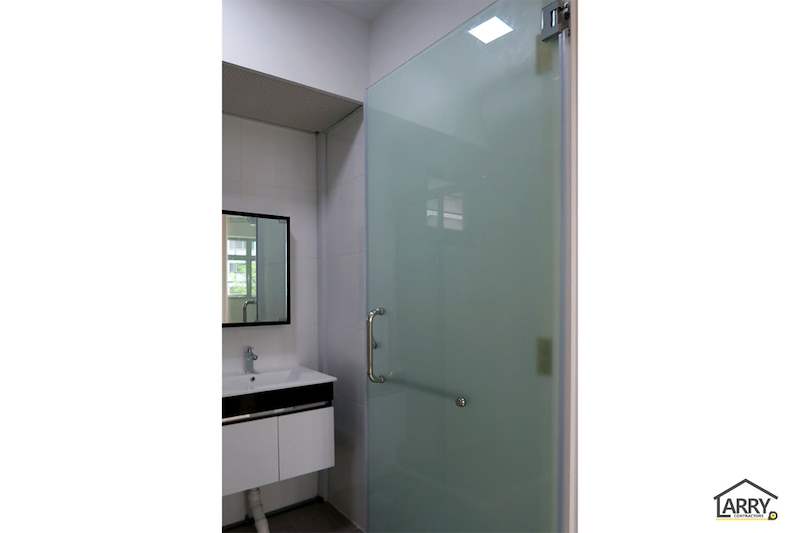 Bathroom with a frosted glass door, a wall-hung vanity and a framed mirror - HDB flat renovation with a platform bay window seat and blue kitchen (C20) | Larry Contractors, HDB Licensed Renovation Contractor, Singapore