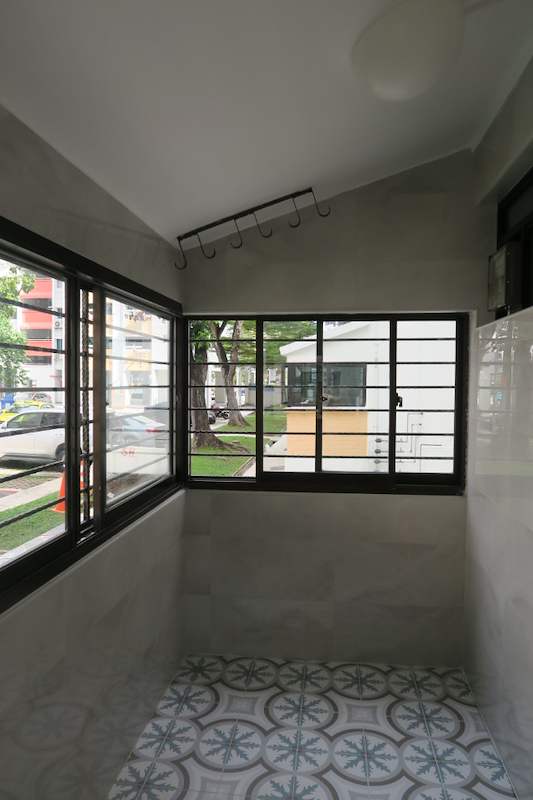 Service yard with black-framed corner windows, wall hooks and patterned floor tiles - HDB kitchen, bathroom and service yard renovation (140PP) | Larry Contractors, HDB Licensed Renovation Contractor, Singapore