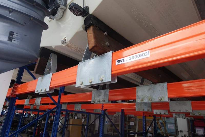 Beam with a safe working load label, galvanised brackets and timber bunks under a stored boat - Heavy-duty storage racking for boats and jet skis (Sentosa) | Larry Contractors, HDB Licensed Renovation Contractor, Singapore