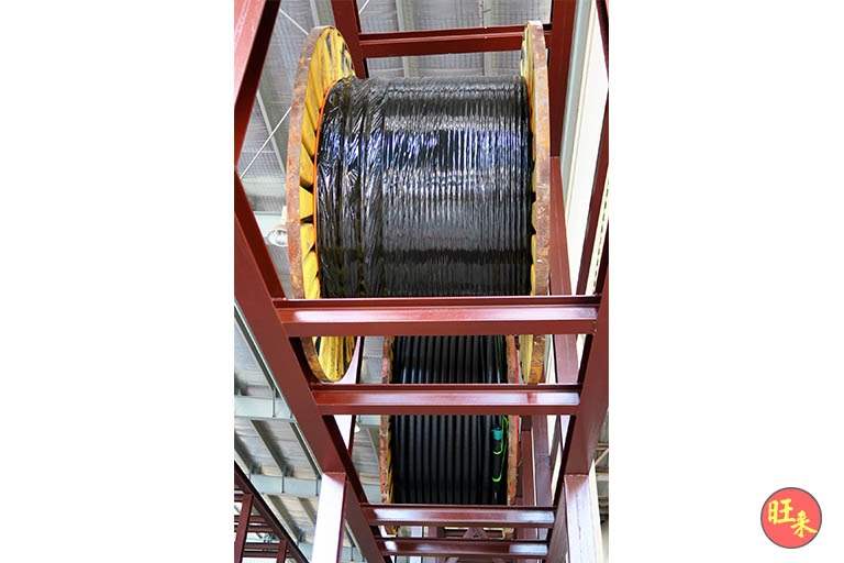 A single large cable drum resting on the primer-painted steel frame - Heavy-duty cable drum racking in a cable yard (TSE) | Larry Contractors, HDB Licensed Renovation Contractor, Singapore