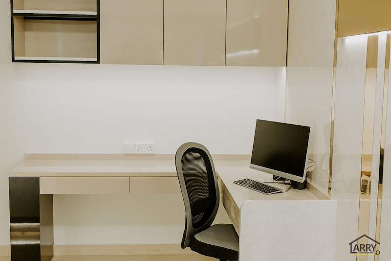 Built-in study desk with a monitor, office chair and overhead cabinets in cream high-gloss laminate - HDB flat renovation in cream and mirror-trim laminate with a galley kitchen (C10) | Larry Contractors, HDB Licensed Renovation Contractor, Singapore