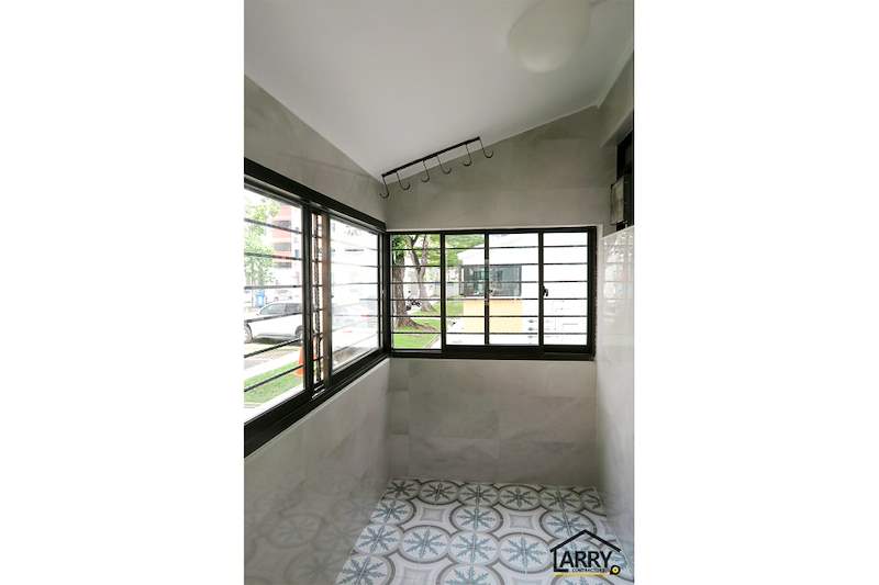 Service yard corner windows with black frames, hooks on the wall and patterned floor tiles - HDB resale flat renovation with polished terrazzo floors, new kitchen and bathrooms (C04) | Larry Contractors, HDB Licensed Renovation Contractor, Singapore