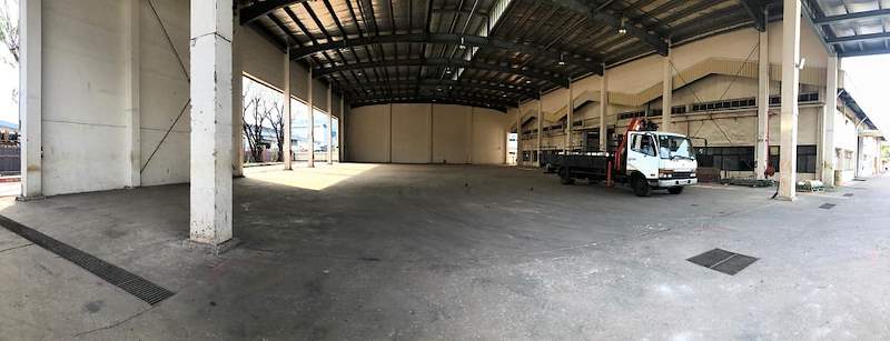 Before: the empty covered shed with a concrete floor and a lorry parked at the far end - Heavy-duty cable drum racking in a cable yard (TSE) | Larry Contractors, HDB Licensed Renovation Contractor, Singapore
