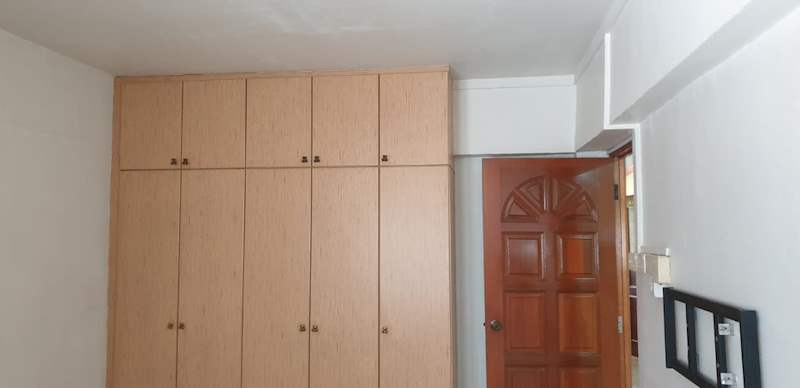 Light wood full-height cabinets beside the timber entrance door - HDB resale flat renovation with polished terrazzo floors, new kitchen and bathrooms (C04) | Larry Contractors, HDB Licensed Renovation Contractor, Singapore