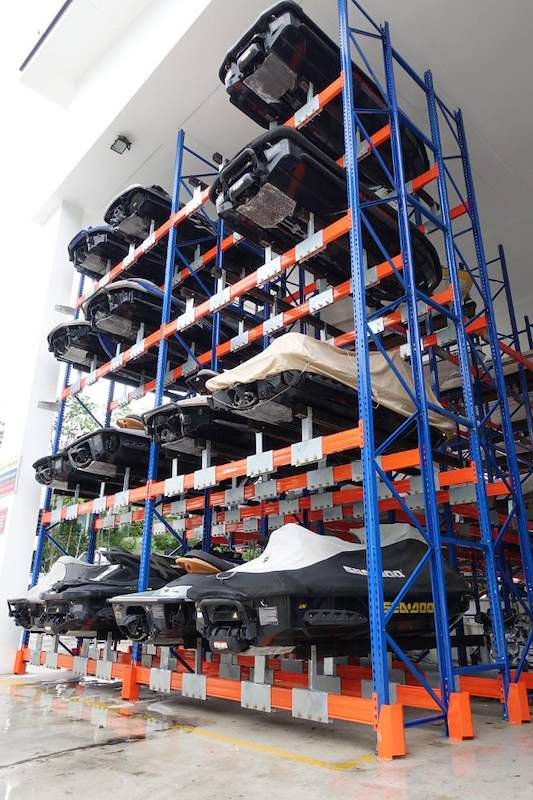 Five-tier jet ski rack fully loaded, with orange base beams and blue uprights - Heavy-duty storage racking for boats and jet skis (Sentosa) | Larry Contractors, HDB Licensed Renovation Contractor, Singapore