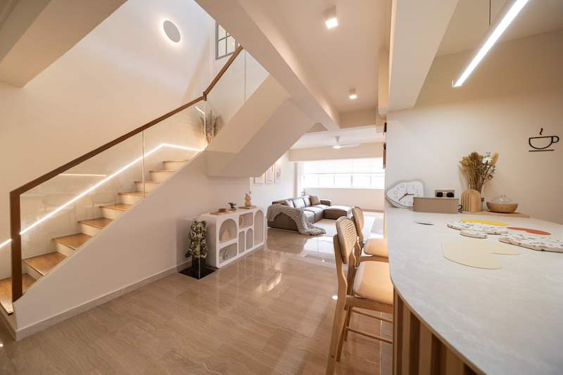 Open-plan living and dining area with the lit staircase, curved island and bar stools - Full HDB maisonette renovation with a curved timber-slat island and lit staircase (140BB) | Larry Contractors, HDB Licensed Renovation Contractor, Singapore