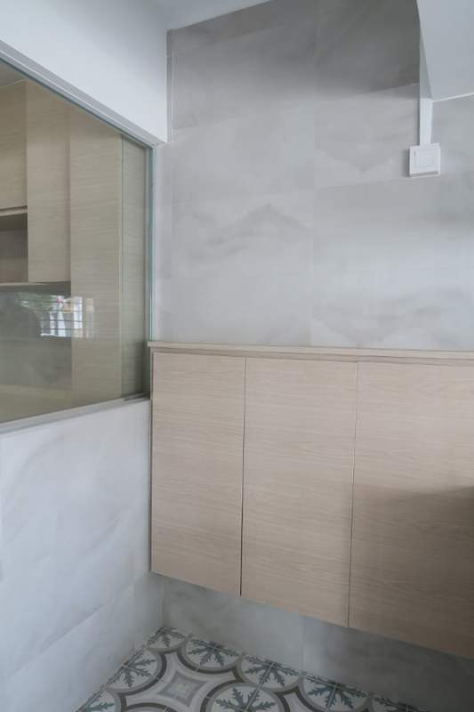 Kitchen corner with a half-height glass partition, light wood cabinet and patterned floor - HDB kitchen, bathroom and service yard renovation (140PP) | Larry Contractors, HDB Licensed Renovation Contractor, Singapore